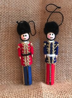 two wooden nutcrackers sitting on top of a cloth covered table next to each other