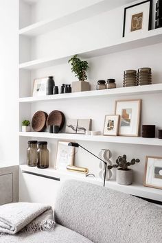 a living room filled with lots of white shelves