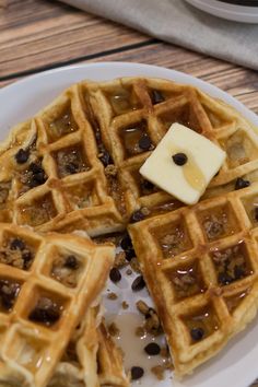 two waffles on a white plate topped with chocolate chips