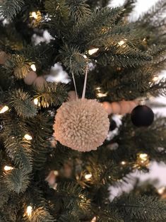 an ornament hanging from the top of a christmas tree