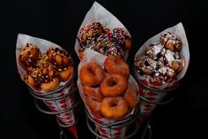 three baskets filled with different kinds of doughnuts