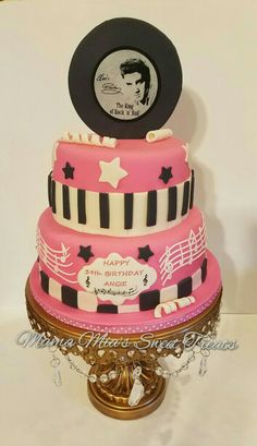 a pink and black cake with elvis presley on top