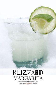 a glass filled with ice and a lime slice on top of it, next to the words blizzard margarita