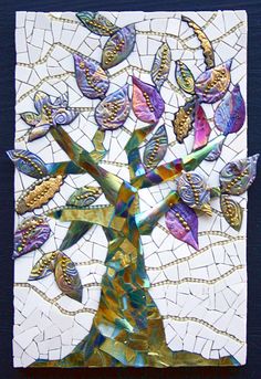 a stained glass tree with birds on it's branches and leaves in the center