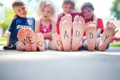 a group of children sitting on the ground with their feet covered in words that read, special message for dad