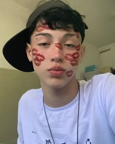 a boy with his face painted red and black