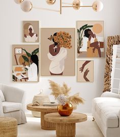 a living room filled with white furniture and paintings on the wall above it's coffee table