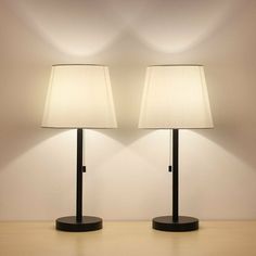 two lamps sitting next to each other on a table