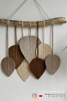 four hearts hanging from a wooden stick on a wall