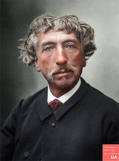 an old man with curly hair and a moustache on his face is shown