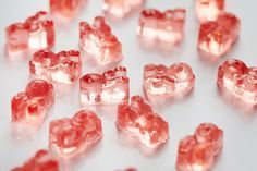 some pink gummy bears on a white surface