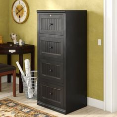 a tall black cabinet sitting in the corner of a room