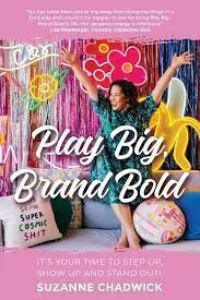 a woman sitting on top of a couch in front of a pink background with the words play big, brand bold