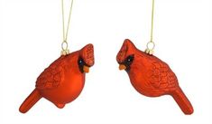 two red glass birds hanging from strings