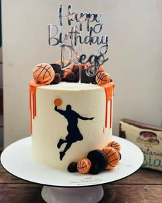 a birthday cake decorated with basketballs and the words happy birthday d e gg