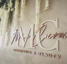 the logo or sign for mrs and mr cama's hair and beauty salon