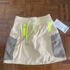 Lululemon Light Tan Multi Pocket Cargo Skirt With Yellow And Gray Detailing. Super Cute For Hiking Or Just Casual Wear. Has Built In Shorts Underneath! Brand New With Tags. Size 4 Hiking Skirt, Lululemon Tennis Skirt, Street Skirt, Lululemon Shirt, Athletic Skort, Black And White Skirt, Cream Yellow, Golf Skirts, Cargo Skirt