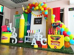 an office decorated with balloons, crayons, and birthday cakes on display