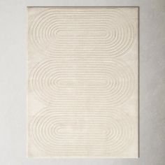 a white rug with wavy lines on it