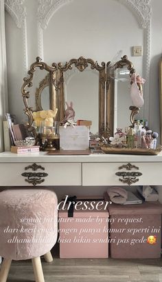 a dresser with an ornate mirror and stool in front of it