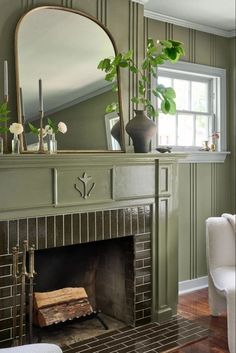 a living room with a fireplace and mirror