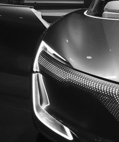 the front end of a black and white sports car