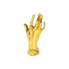 a gold colored hand statue on a white background