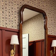 a bathroom mirror sitting on top of a wooden counter