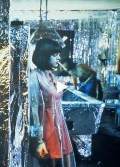 a woman standing in front of a table covered in tin foil