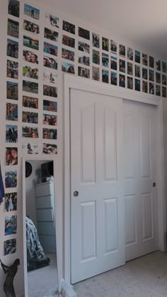 a bedroom with pictures on the wall and door to another room in front of it