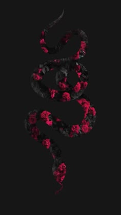 a snake with red and black flowers on it's tail, in the dark