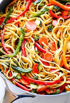 a skillet filled with pasta and vegetables