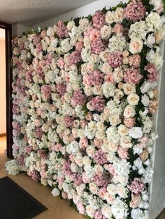 the wall is covered with pink and white flowers