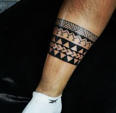 a man's leg with a tattoo on it that has an arrow in the middle