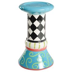 a blue and white vase sitting on top of a wooden table next to a black and white checkerboard design