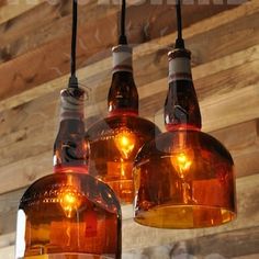 three light fixtures hanging from a wooden ceiling