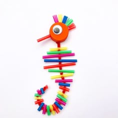 a toy made out of plastic sticks with a eye on it's head and eyes in the shape of a seahorse