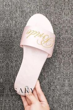 someone is holding up their pink slippers with the word happy written on one side