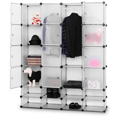 an open closet with clothes and shoes on it