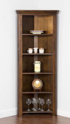 a tall wooden shelf with wine glasses on it