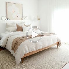 a bedroom with white walls and beige bedding