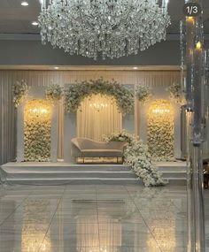 an elegant wedding setup with chandelier and flowers