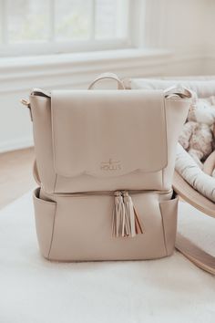 a white purse sitting on top of a wooden chair