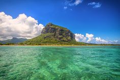 an island in the middle of clear water