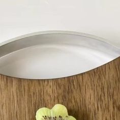 a kiwi cut in half sitting on top of a cutting board