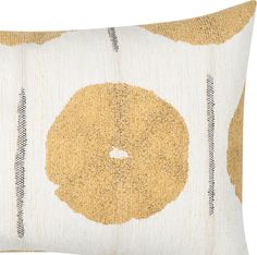 a yellow and white pillow with circles on it