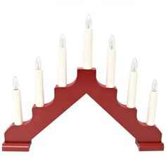 a red candle holder with white candles on it's sides and one in the middle