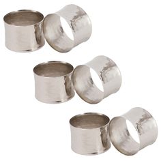 four stainless steel napkin rings are shown in three different sizes and shapes, each with an individual size