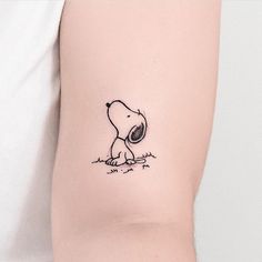 a person with a small tattoo on their arm that has a drawing of a dog