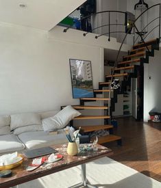 a living room filled with furniture and a spiral staircase